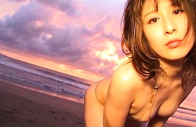 Mari Okamoto Asian fondles her boobies and licks candy at beach