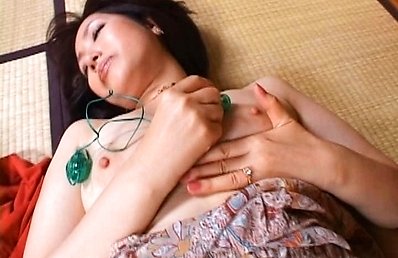 Aya Masuo uses a small vibrator on her sensitive nipples and clit