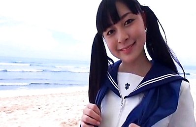 Risa Kobuna Asian takes uniform off and puts sun cream on beach