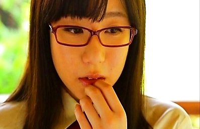 Hino Mai Asian with specs enjoys candy after her ballet exercises