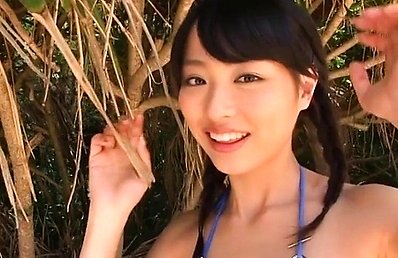 Rio Uchida Asian with pigtails and bath suit plays on the beach